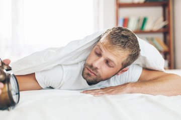 Man finding it difficult to wake up in the morning