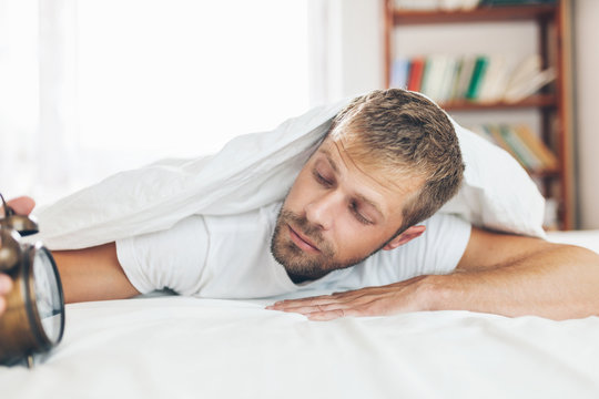 Man finding it difficult to wake up in the morning