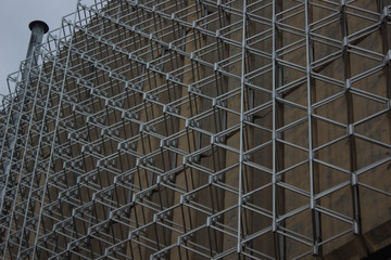 abstract metal wall construction shapes of factory industrial building background texture with noise pollution