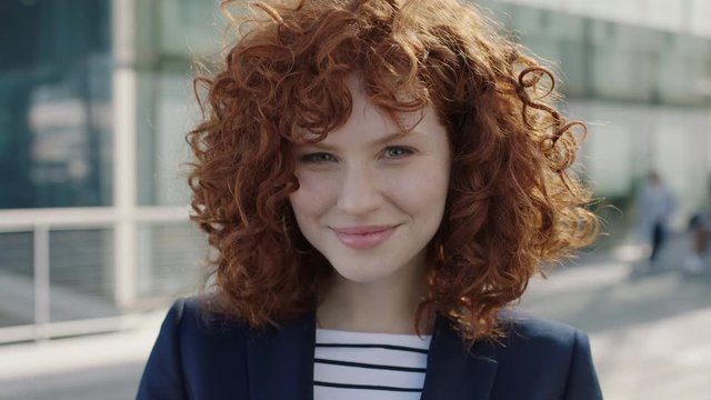 young red head business woman portrait smiling happy intern campus