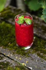 Raspberry smoothies with mint on rustic background