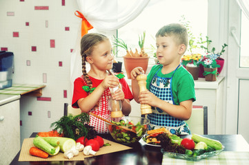 children prepare Breakfast .Brother and sister make vegetable salad. Healthy eating concept