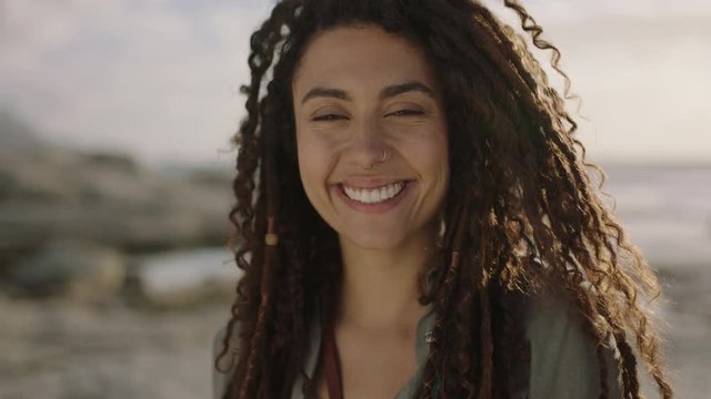portrait of happy mixed race woman smiling cheerful at beach