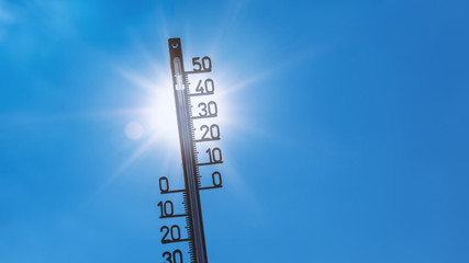Summer backround: bright sun with thermometer and more than 30 degree