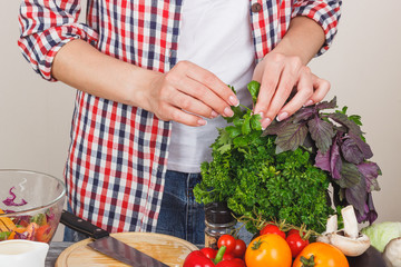 Woman cooks at the kitchen