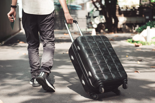 Young man and traveling luggage suitcase walking