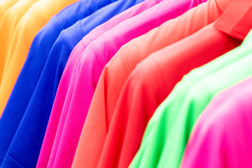 Colorful clothes hanging on a hanger, top