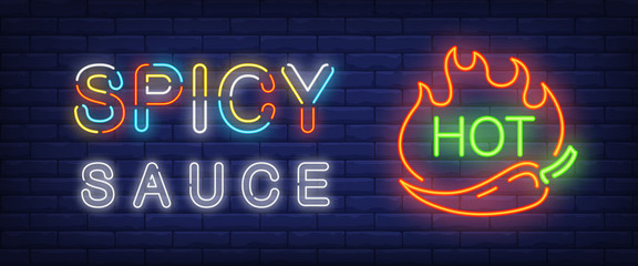 Spicy sauce, hot neon text with chili pepper and fire flames. Cafe or restaurant advertisement design. Night bright neon sign, colorful billboard, light banner. Vector illustration in neon style.