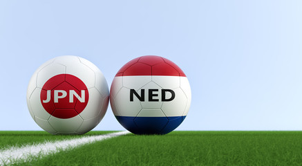 Japan vs. Netherland Soccer Match - Soccer balls in Japan and Netherlands national colors on a soccer field. Copy space on the right side - 3D Rendering  © Marius Faust