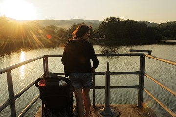 Mother and Child on Lake Jetty in Sunset