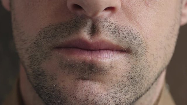 close up caucasian man mouth unshaved facial hair stubble