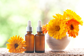Bottles with flower calendula oil on nature backgraund, bio, organic , nature cosmetics concept