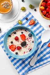 Photo of oatmeal, coffee, raspberries, strawberries, gooseberries, cherries