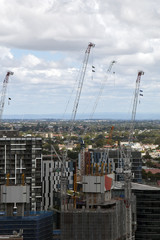 Fototapeta na wymiar Sydney Australia, New high rise towers under construction with urban sprawl in background