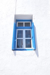 Blue Greek Typical Window In Ano Mera On The Island Of Mykonos. Architecture Landscapes Travels Cruises. July 3, 2018. Ano Mera, Island of Mikonos Greece.