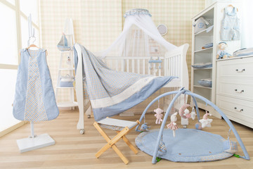Fototapeta na wymiar Simple, white baby bedroom with cot and rug
