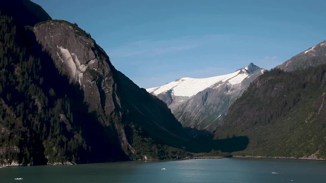 Snow capped mountains surround Tracy Arm Fjord near Juneau, Alaska. This protected natural wilderness is filled with wildlife and an incredible landscape. Slow motion.