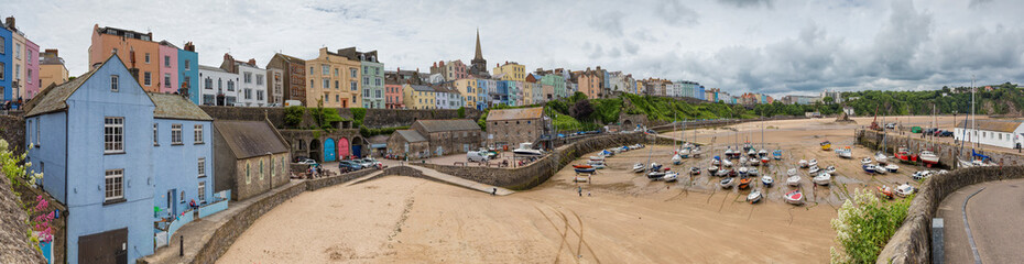 Fototapeta premium Tenby fishing port harbour at low tide, captured in a panoramic view