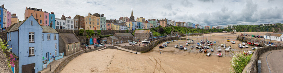 Tenby fishing port harbour at low tide, captured in a panoramic view