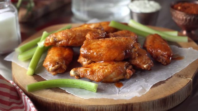 Parallax slider footage of delicious chicken wings with sauce and blue cheese dip.