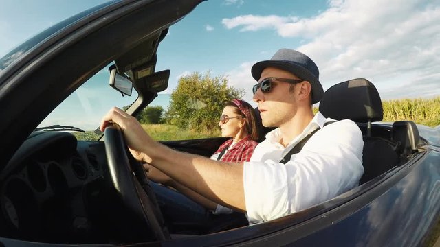 4K footage: Young couple starts them cabriolet car trip and have a fun