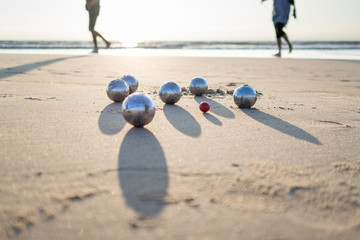 petanque balls on sandy beach