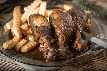 Fried chicken drumsticks with chips.
