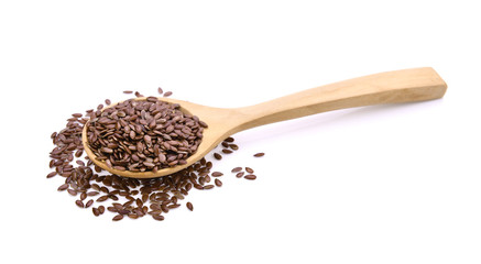 Flax seeds heap in wood spoon on white background