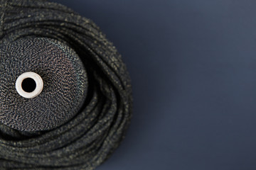 Black and gold colour skein on the textile and black background