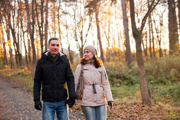 Fototapeta premium Young girl with guy in autumn park