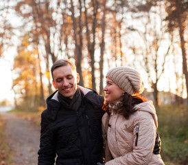 Fototapeta premium Young couple on walk in autumn park.