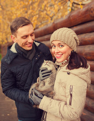 girl and  guy with cat in autumn  park