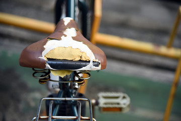 Old bicycle seat torn. Old and damage torn bicycle saddle seat with effect.