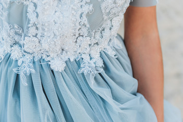 Close up of details on a light blue wedding dress