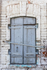 Texture of a vintage wooden closed window close-up, on a brick white background