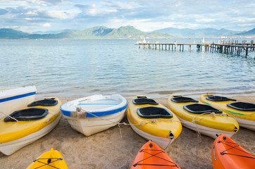 kayak and small boat on the beach