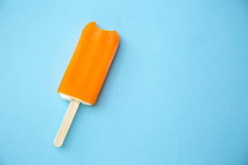 Popsicle with fresh orange on a table