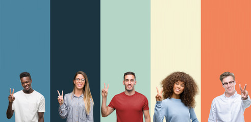 Group of people over vintage colors background showing and pointing up with fingers number two...