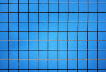 metal grille with square cells on a blue background
