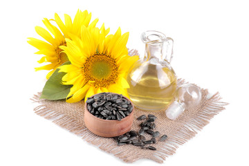 Big beautiful yellow sunflower with leaf and sunflower seed oil and seeds on a white isolated background