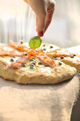 Pizza with salmon and basil and capers. Traditional Italian pastries. Copy space.