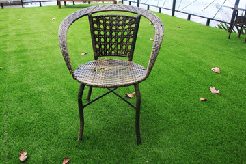 A chair put on the green grass stadium.