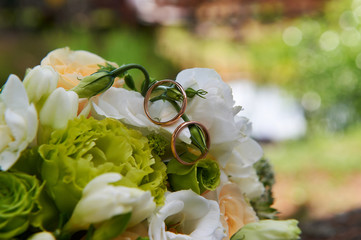 Wedding rings on flower bouquets.