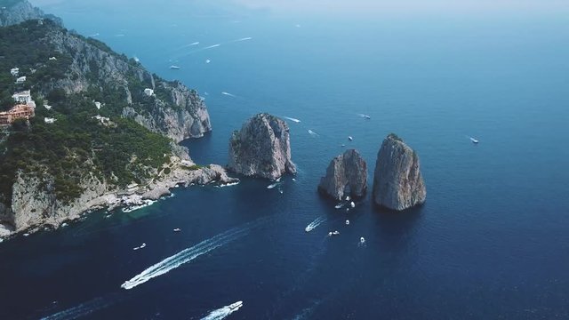Aerial view of Faraglioni cliffs and Tyrrhenian Sea on Capri Island, Italy