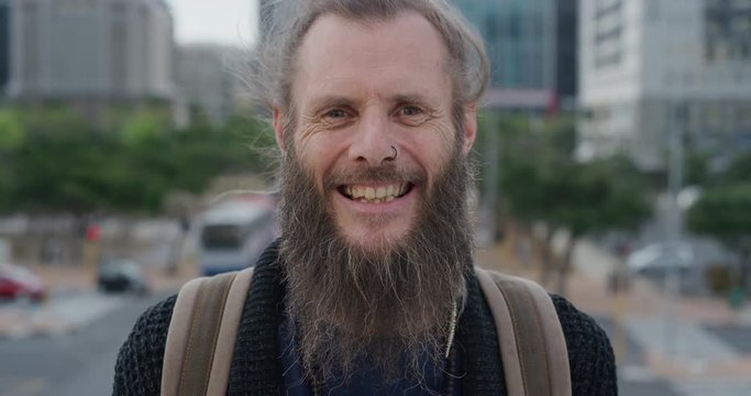 portrait mature bearded hippie man laughing happy enjoying carefree urban lifestyle homeless beggar in city wearing nose ring