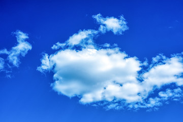 Fototapeta na wymiar Fluffy white clouds on background of blue sky wallpaper