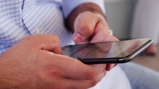 Man scrolling through social media and texting on phone.