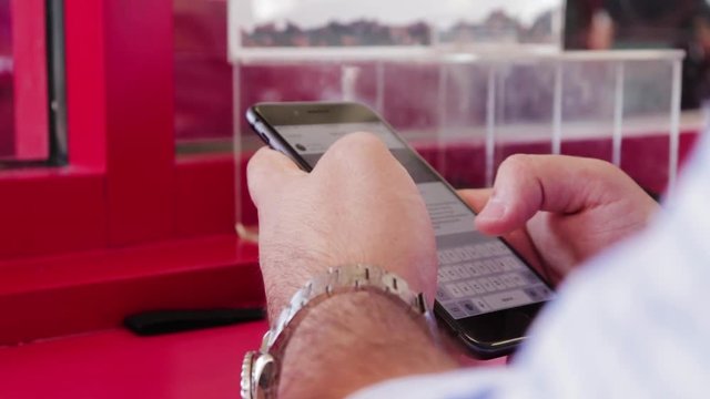 Man scrolling through social media and texting on phone.