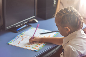 Girl is doing his homework for elementary school.