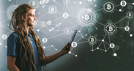 Bitcoin with young man using his tablet